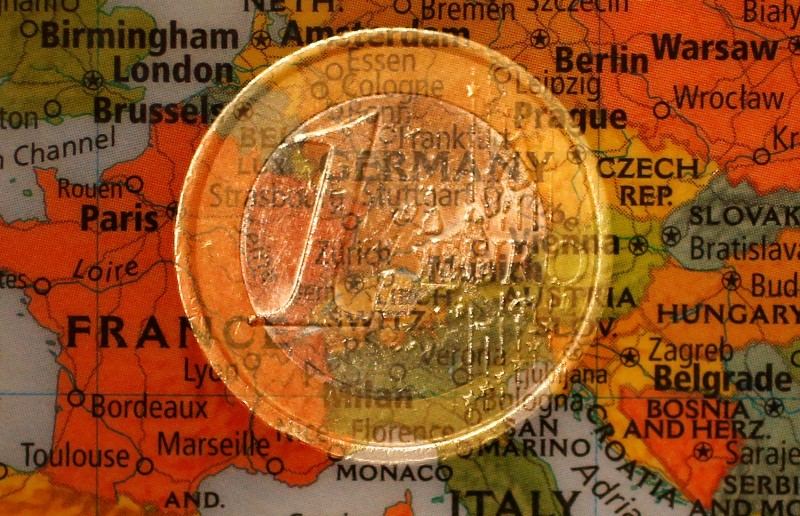 © Reuters. A picture illustration taken with the multiple exposure function of the camera shows a one Euro coin and a map of Europe