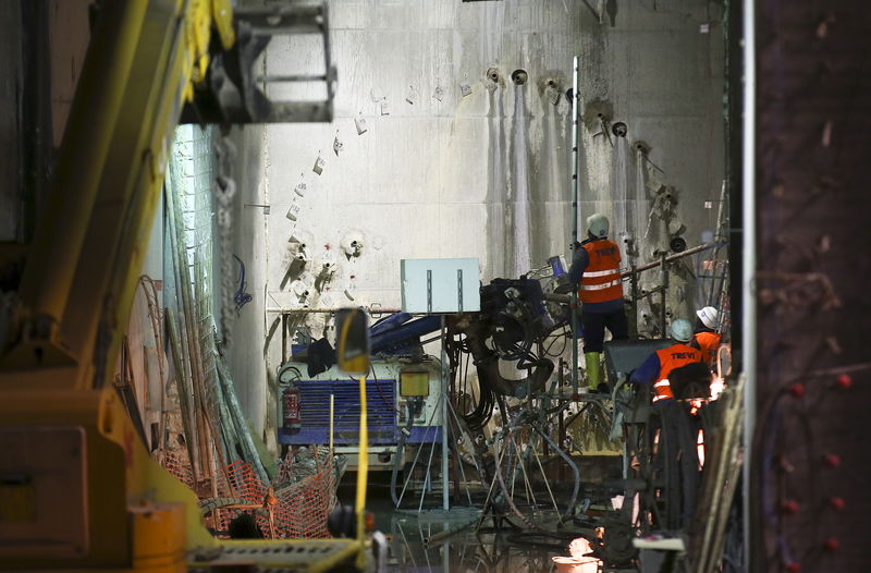 © Reuters. Workers are seen at the site of a metro railway tunnel under construction at the 