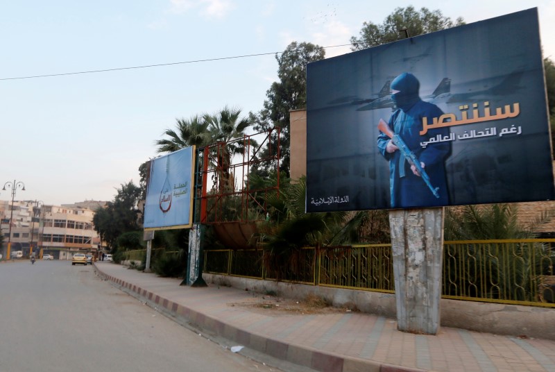 © Reuters. Islamic State billboards are seen along a street in Raqqa