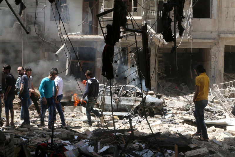 © Reuters. Pessoas inspecionam local atingido por ataques em Aleppo 