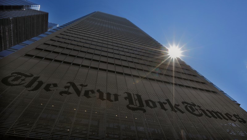 © Reuters. The sun peaks over the New York Times Building in New York