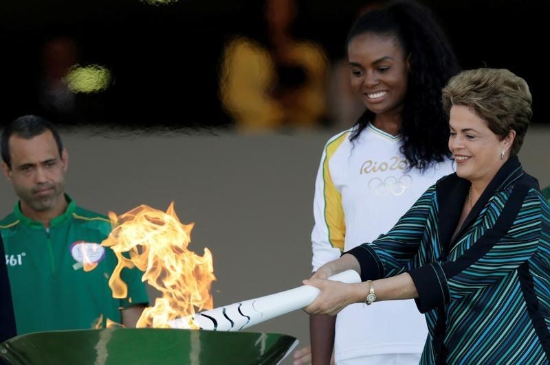 © Reuters. رئيسة البرازيل توقد الشعلة الأولمبية وسط اضطرابات سياسية