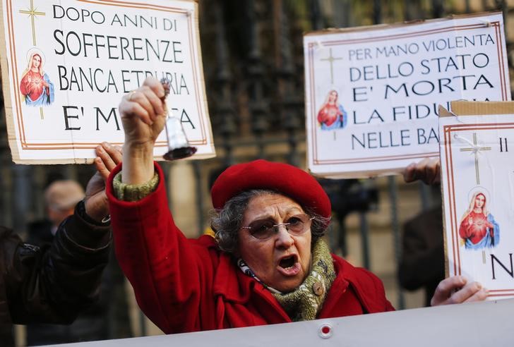 © Reuters. A woman reacts in front of the Bank of Italy during a protest after a bank rescue last month left bitter families marooned, in downtown Rome