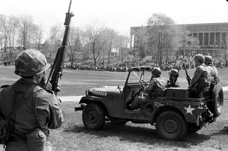 © Reuters. Members of the Ohio National Guard watch from a distance as students gather in the commons at Kent State University in Kent to protest the war in Vietnam 
