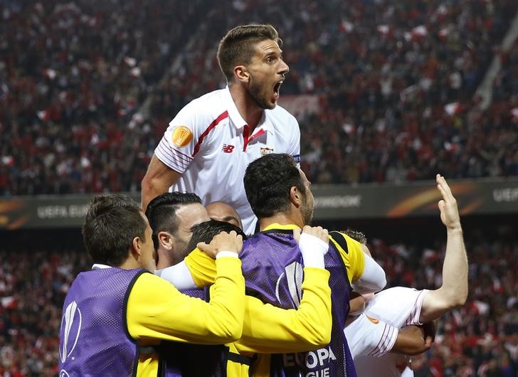 © Reuters. Foto del jueves del jugador del Sevilla Mariano Ferreira celebrando su gol con Daniel Carrico y sus compañeros en el partido por las semifinales de la Liga Europa