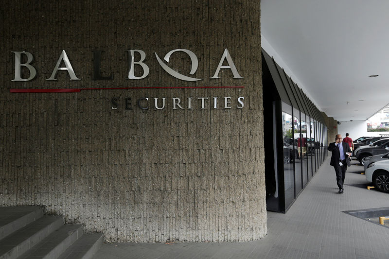 © Reuters. A man walks pass the Balboa Bank entrance in Panama City