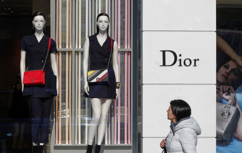 © Reuters. A woman walks past a Dior shop in downtown Brussels