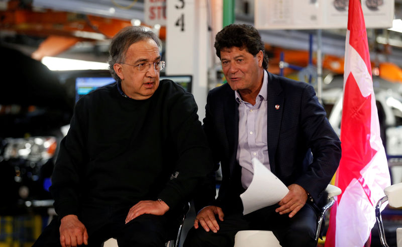 © Reuters. FCA CEO Sergio Marchionne sits with Unifor union president Jerry Dias during the celebration of the production launch of the all-new 2017 Chrysler Pacifica minivan at the FCA Windsor Assembly plant in Windsor