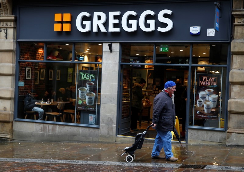 © Reuters. A man walks past a Greggs bakery in Bradford, Britain