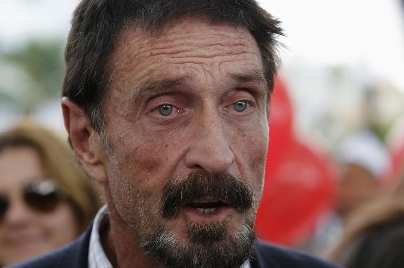 © Reuters. Computer software pioneer McAfee speaks with reporters outside his hotel in Miami Beach