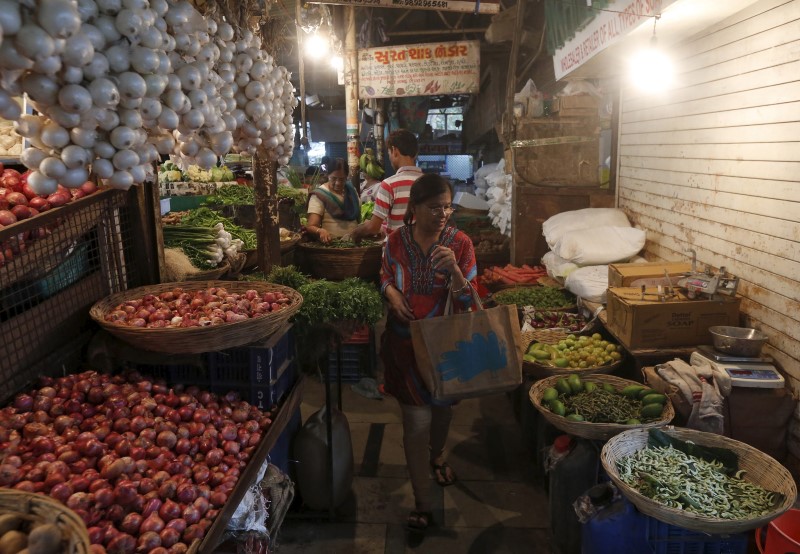 © Reuters. A woman shops at a vegetable market in a residential area in Mumbai