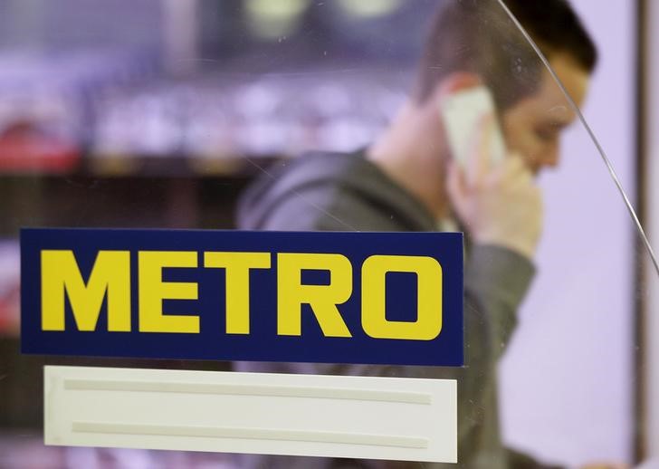 © Reuters. File photo of a man walking past the logo of Germany's biggest retailer Metro AG at its cash and carry market in the western German city of Sankt Augustin