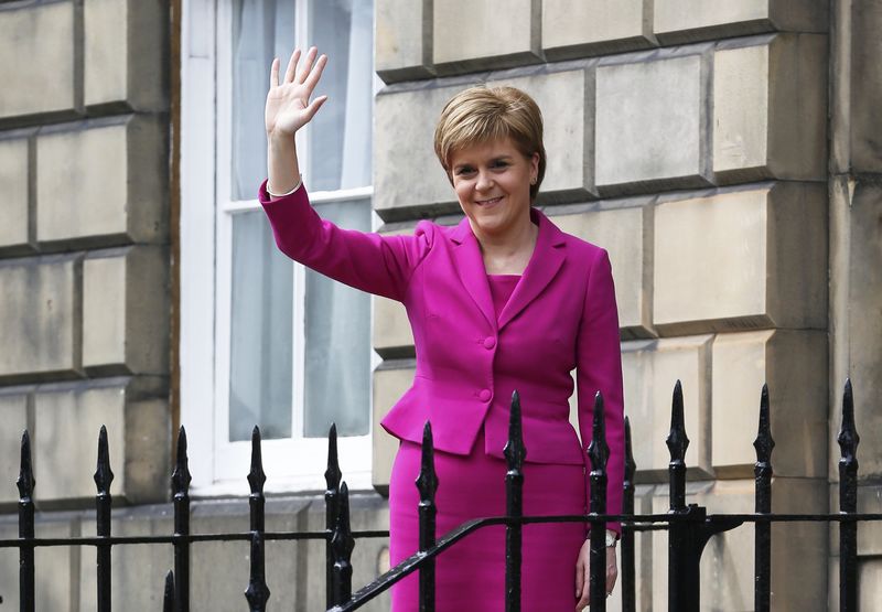 © Reuters. Scotland's First Minister and SNP leader Nicola Sturgeon waves as she stands outside Buth House in Edinburgh