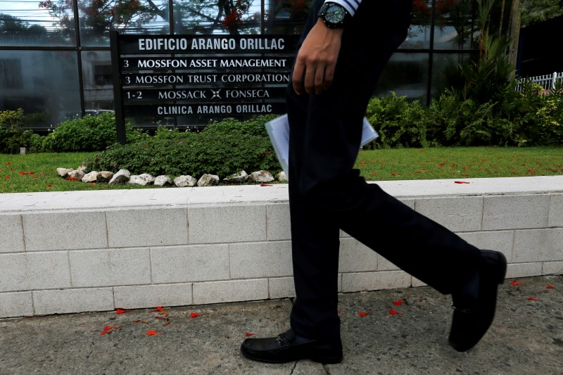 © Reuters. A man walks past a company list showing the Mossack Fonseca law firm at the Arango Orillac Building in Panama City