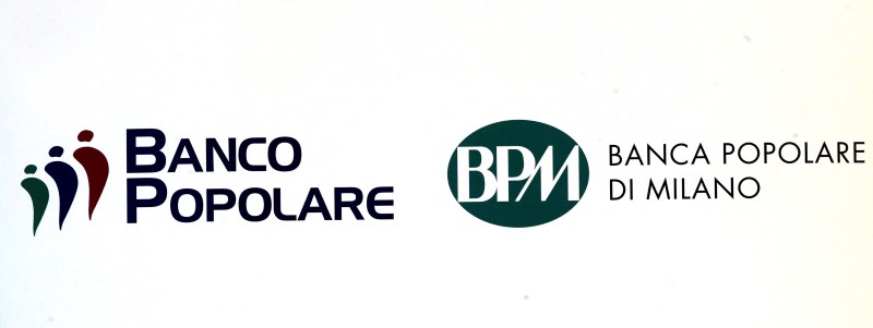 © Reuters. Banca Popolare di Milano (BPM) logo and Banco Popolare's logo are seen on placard during business plan meeting in Milan