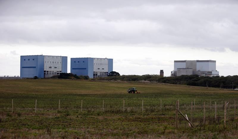 © Reuters. File picture of a tractor mowing a field on the site where EDF Energy's Hinkley Point C nuclear power station will be constructed in Bridgwater, southwest England