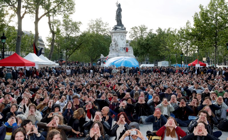 © Reuters. Supporters of social media-driven movement "Nuit Debout" (Rise up at Night), shout during an event in Paris