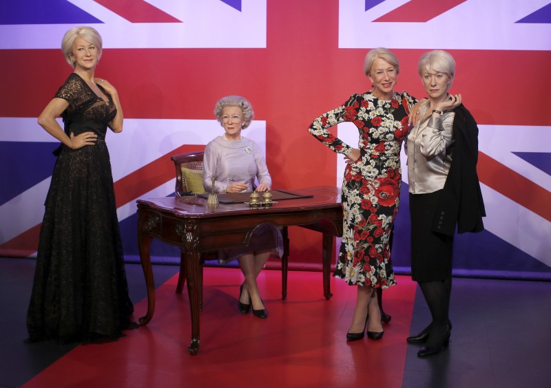 © Reuters. British actor Helen Mirren poses with waxwork models of herself at Madame Tussauds in London