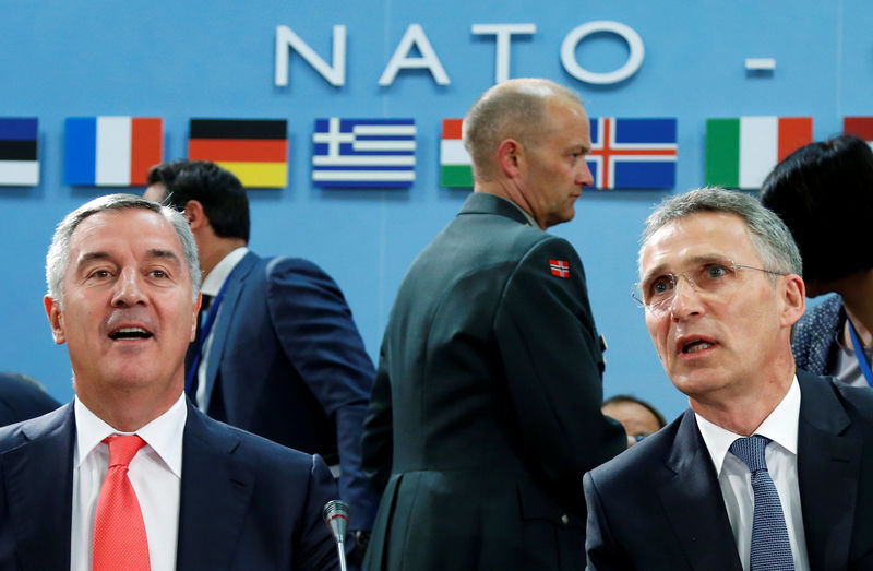 © Reuters. Montenegro's PM Djukanovic and NATO Secretary-General Stoltenberg attend a NATO foreign ministers meeting in Brussels