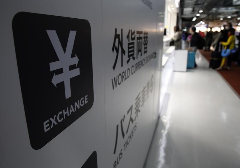 © Reuters. A Japanese Yen currency sign is seen at a currency exchange office as people line up to exchange money at Narita International airport
