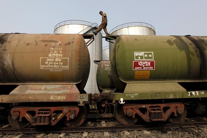 © Reuters. File photo of a worker walking atop a tanker wagon to check the freight level at an oil terminal on outskirts of Kolkata