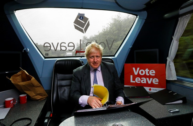 © Reuters. Former London Mayor Boris Johnson works in the back of the Vote Leave bus as it heads towards Exeter