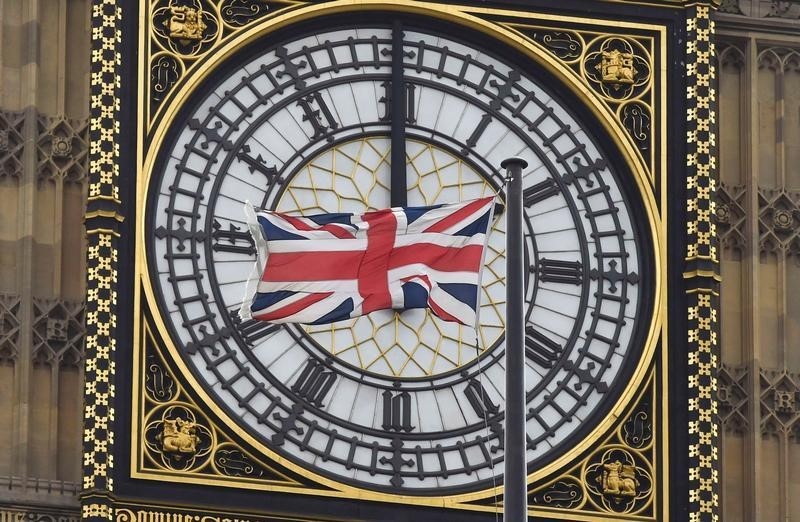 © Reuters. A British Union flag flutters in front of one of the clock faces of the 'Big Ben' clocktower of The Houses of Parliament in central London