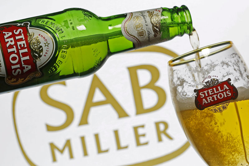 © Reuters. Photo illustration of beer flowing from a bottle of Stella Artois into a glass 