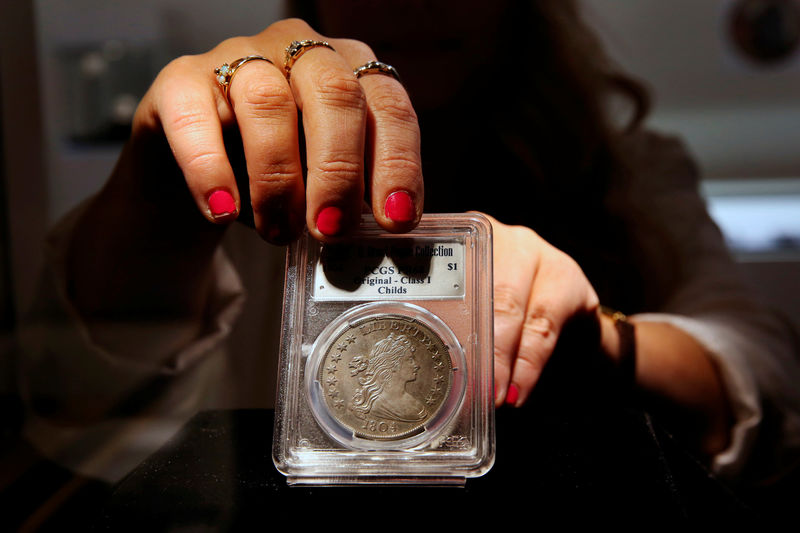 © Reuters. A Sotheby's employee adjusts the Sultan of Muscat-Brands-Childs 1804 Silver Dollar which is displayed as part of the D. Brent Pogue collection to be sold on Tuesday at Sotheby's in New York