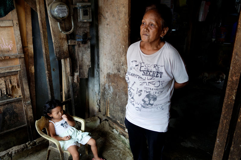 © Reuters. Clarita Alia stands at her home while talking about her four sons which have died in execution-style killings in Davao