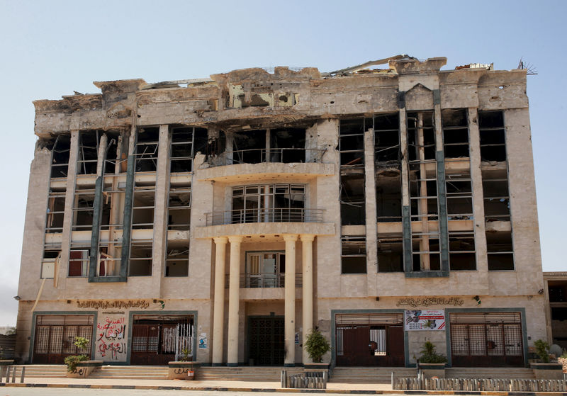 © Reuters. A building damaged during clashes is seen in Benghazi