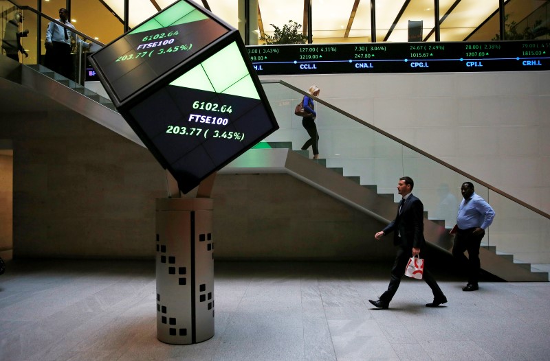 © Reuters. File photo of people walking through the lobby of the London Stock Exchange in London