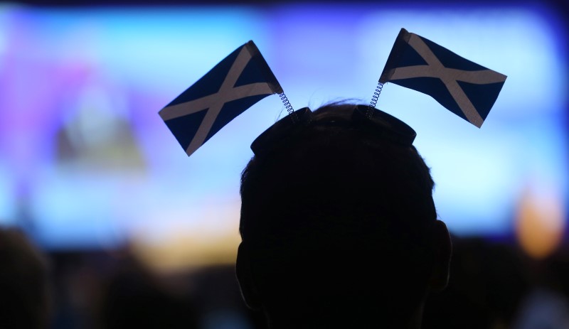 © Reuters. A delegate listens to a speech during the  SNP's Spring Conference in Glasgow, Scotland