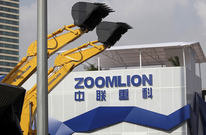 © Reuters. A Zoomlion company logo is seen next to its excavators at an exhibition in Shanghai