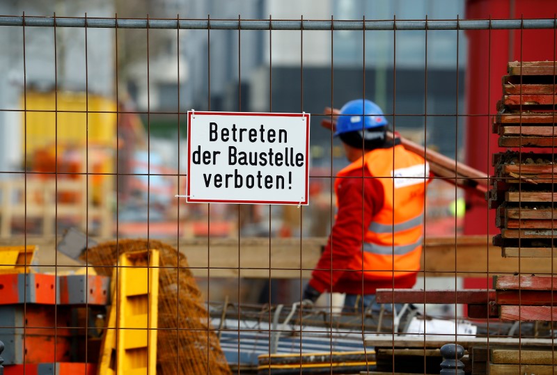 © Reuters. A worker of German construction company Hochtief walks over a construction site in Essen