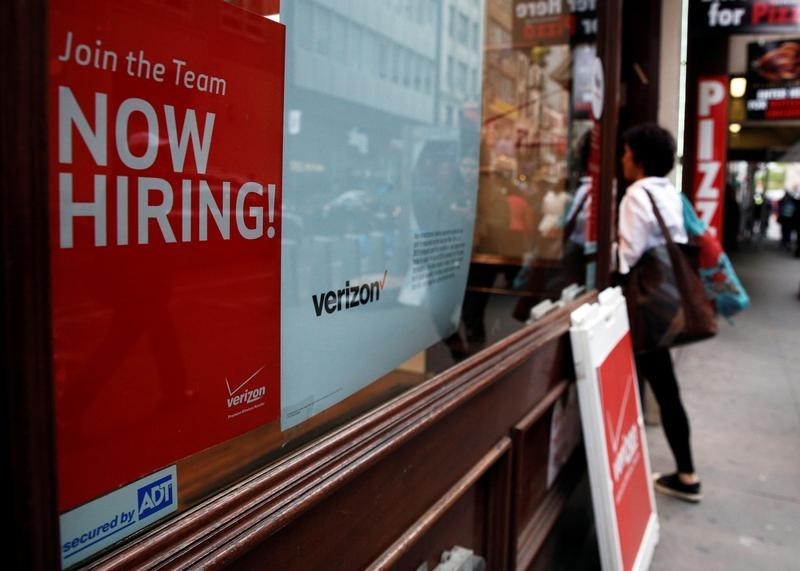 © Reuters. A "Now Hiring" sign is posted on a Verizon store in Manhattan in New York