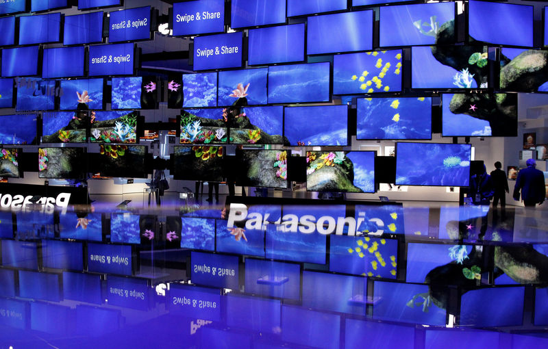 © Reuters. People pass television installation at Panasonic pavilion before start of IFA consumer electronics fair in Berlin