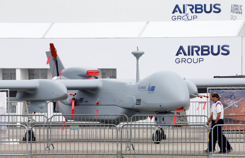 © Reuters. Visitors walk past a surveillance unmanned air vehicle (UAV) 'Heron TP' by IAI and Airbus Defence at the ILA Berlin Air Show in Schoenefeld