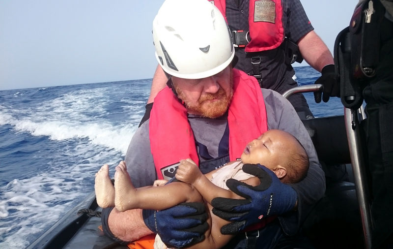 © Reuters. A German rescuer from the humanitarian organisation Sea-Watch holds drowned migrant baby of the Libyan cost