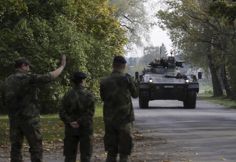 © Reuters. German army soldiers in their infantry fighting vehicle, the "Marder", arrive for the NATO military drill in Adazi