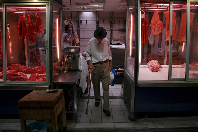 © Reuters. A man exits a butcher shop at the main food market in central Athens