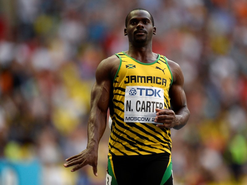 © Reuters. Carter of Jamaica reacts after winning his men's 100 metres heats during the IAAF World Athletics Championships in Moscow