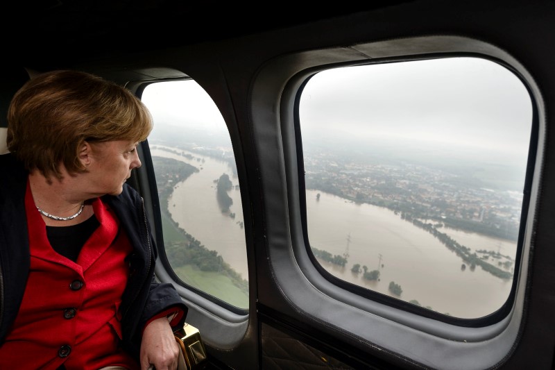 © Reuters. German Chancellor Angela Merkel looks down at flood damage from a helicopter during a flight between Dresden and Pirna