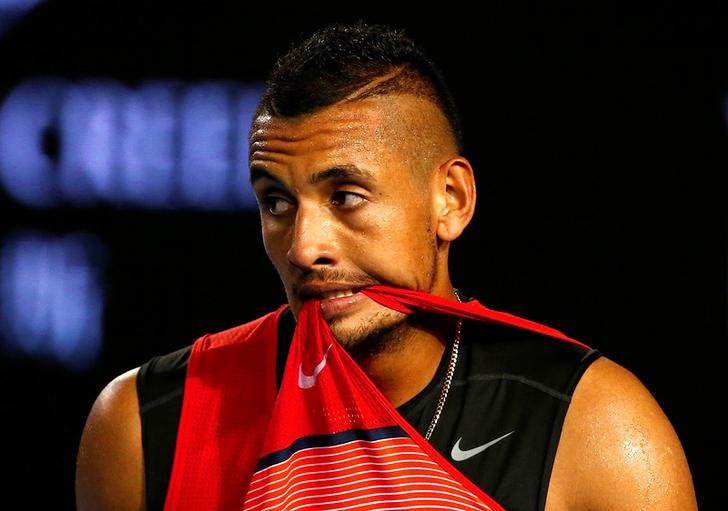 © Reuters. Australia's Kyrgios bites his shirt during his third round match against Czech Republic's Berdych at the Australian Open tennis tournament at Melbourne Park