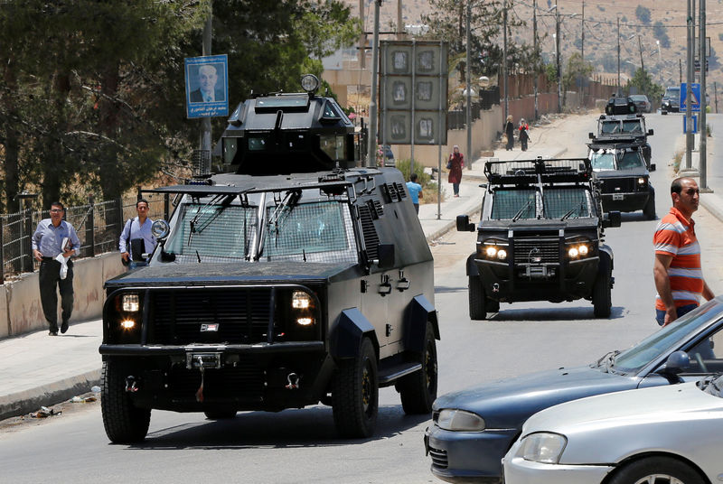 © Reuters. Jordanian security vehicles seen near the General Intelligence directorate offices near al Baqaa Refugee Camp