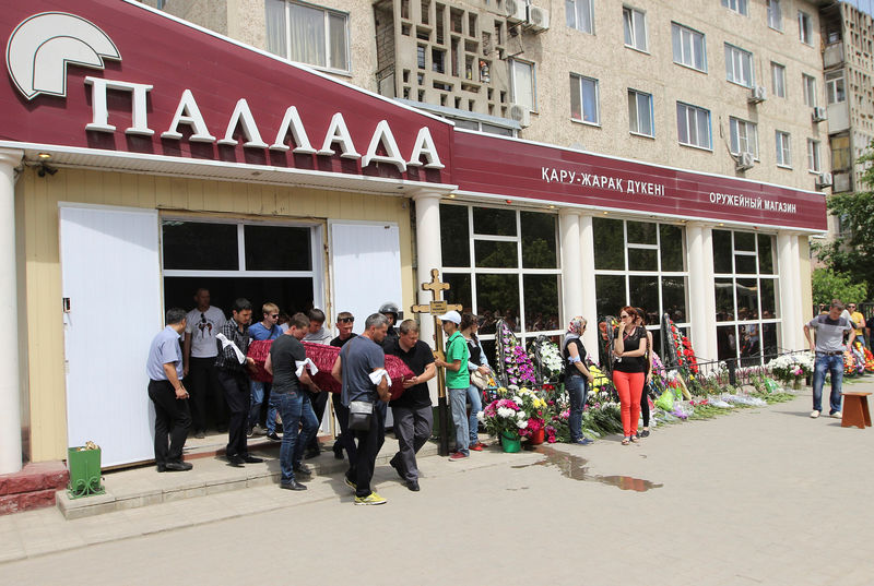 © Reuters. People attend a funeral of the firearms shop salesman Maksimenko, a victim of recent suspected Islamist militant attack in Aktobe