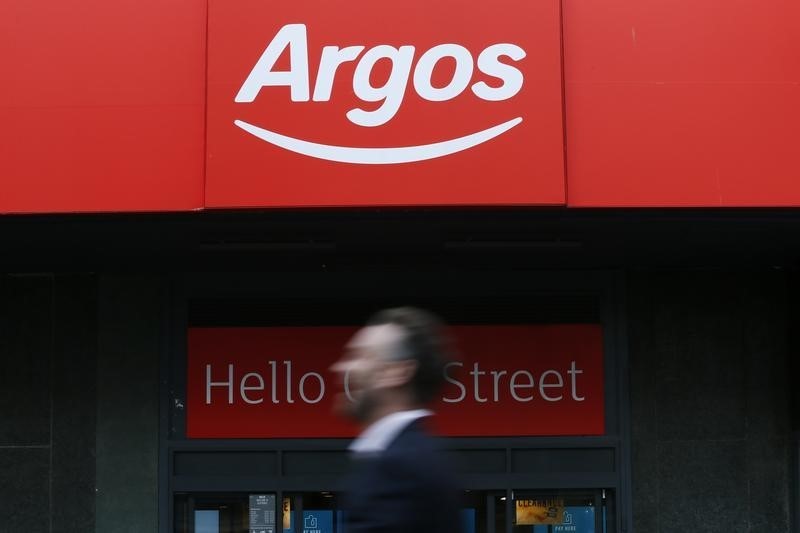 © Reuters. File photo of a pedestrian walking past an Argos store in London