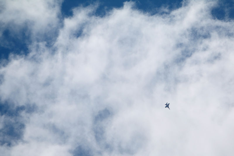 © Reuters. A military aircraft flies over Manbij city