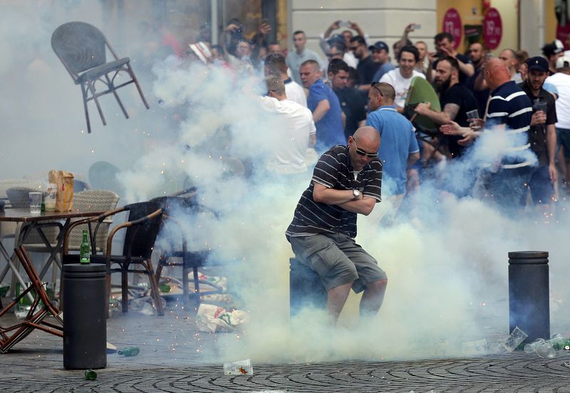 © Reuters. A teargas grenade explodes near an England fan ahead of England's EURO 2016 match in Marseille