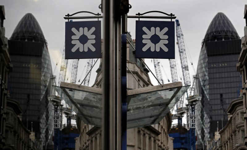 © Reuters. A logo of the Royal Bank of Scotland (RBS) is reflected in the window of a branch office in London